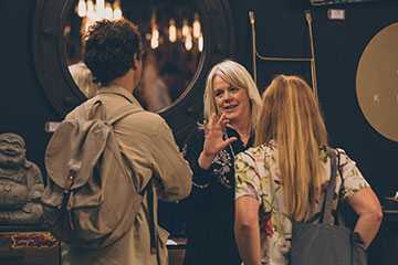 Stall holder discussing a product with customers at Autumn Fair