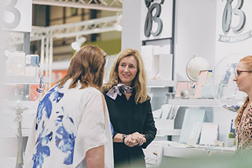 Stall holder discussing a product with customer at Autumn Fair