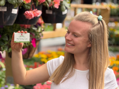 British Garden Centres woman holding loyalty card
