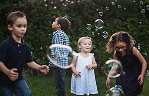 Children playing in garden - 5 simple steps to eliminate germs from garden toys