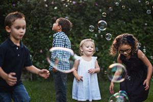 Children playing in garden - 5 simple steps to eliminate germs from garden toys