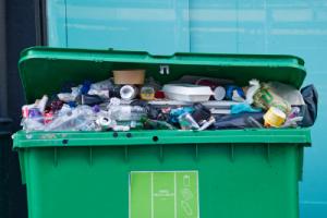 An overflowing commercial bin